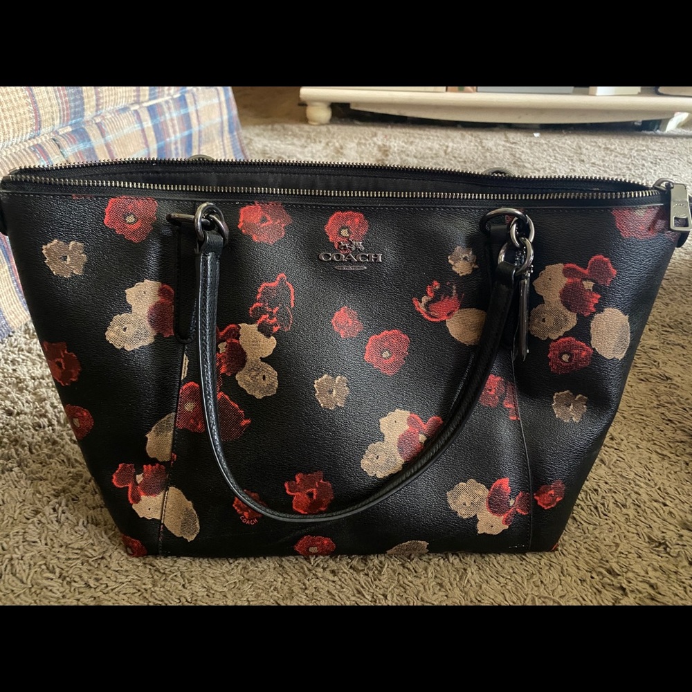 Black never used coach bag. Has red and fan floral design